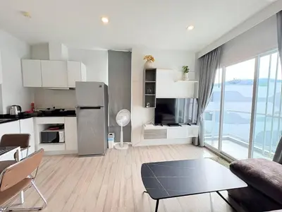 a kitchen and living room with a refrigerator and a table at The closest accommodation next too central Mall in Ban Rangeng