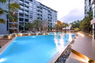 a large swimming pool in front of a building at Deluxe 1BR Pool view 58SQM in Kamala Condo Citygate P302 in Kamala Beach