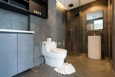a bathroom with a white toilet and a shower at Deluxe 1BR Pool view 58SQM in Kamala Condo Citygate P302 in Kamala Beach
