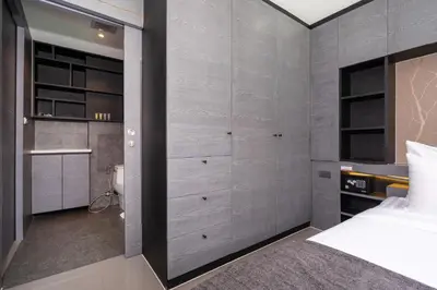 a bedroom with a bed and some drawers and cabinets at Deluxe 1BR Pool view 58SQM in Kamala Condo Citygate P302 in Kamala Beach
