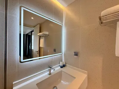 a bathroom with a sink and a mirror at Sunshine BEACH FRONT in Layan Beach