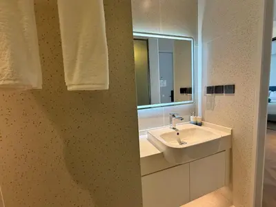a bathroom with a sink and a mirror at Sunshine BEACH FRONT in Layan Beach
