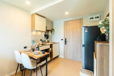 a kitchen with a table and chairs in a room at 1BR near Laguna, Space Cherngtalay, Bangtao beach by Pat in Ban Thalat Choeng Thale