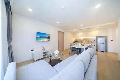 a living room with a couch and a table at Phuket Family apartment in Phuket Town