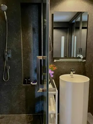 a bathroom with a white sink and a mirror at The Kamala View in Kamala Beach
