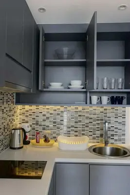 a kitchen with a sink and a counter with dishes at The Kamala View in Kamala Beach