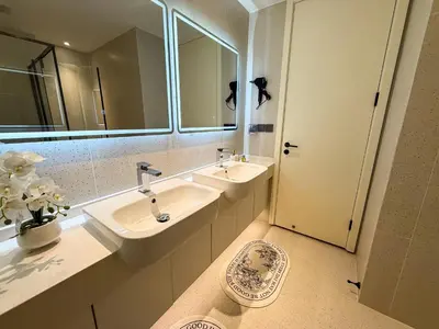 a bathroom with two sinks and a mirror at Sunshine Layan Beach Resort 2 bedroom #84192 in Layan Beach