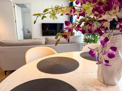 a table with a vase of flowers on top of it at Sunshine Layan Beach Resort 2 bedroom #84192 in Layan Beach