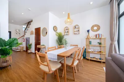 a dining room with a table and chairs at Holistic Haven Private Pool Villa at Kamala Newest Residence in Kamala Beach