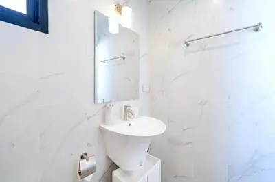a white bathroom with a sink and a mirror at Holistic Haven Private Pool Villa at Kamala Newest Residence in Kamala Beach