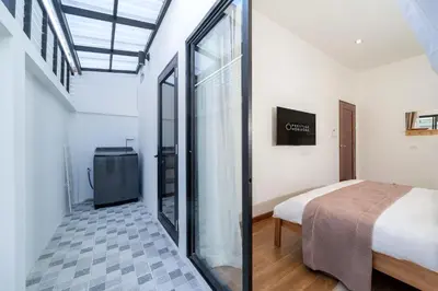 a bedroom with a bed and a window in a room at Holistic Haven Private Pool Villa at Kamala Newest Residence in Kamala Beach