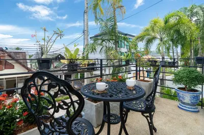a table and two chairs on a balcony at Villa Mangosteen 3BR Seaview Pool and Rooftop in Ban Saiyuan (1)