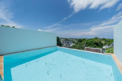 a large blue swimming pool on the roof of a house at Villa Mangosteen 3BR Seaview Pool and Rooftop in Ban Saiyuan (1)
