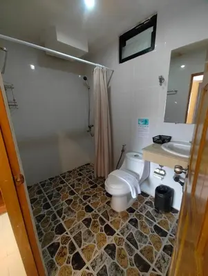 a bathroom with a toilet and a sink at OYO Dynasty Hotel in Patong Beach