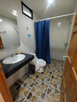 a bathroom with a sink and a toilet and a mirror at OYO Dynasty Hotel in Patong Beach