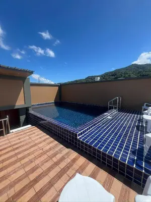 a swimming pool on the roof of a house at OYO Dynasty Hotel in Patong Beach