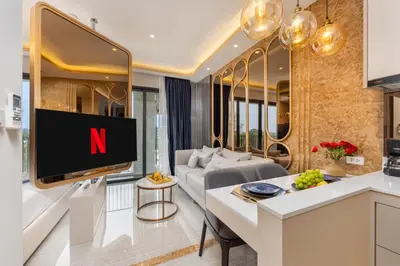 a living room with a tv with the n on it at Suite Imola Gym Pool Close to Beach – Bellevue in Laguna Phuket