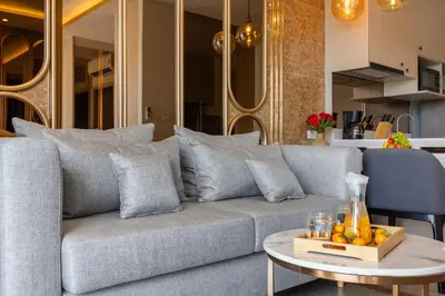 a living room with a couch and a table at Suite Imola Gym Pool Close to Beach – Bellevue in Laguna Phuket