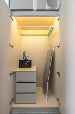 a walk in closet with a clock and a drawer at Suite Imola Gym Pool Close to Beach – Bellevue in Laguna Phuket