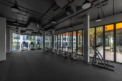 a gym with treadmills and elliptical machines at Suite Imola Gym Pool Close to Beach – Bellevue in Laguna Phuket