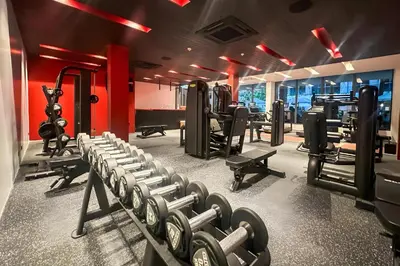 a gym with several rows of tread machines at Layan Green Park by Search Estate 1 bedroom in Ban Nong Chaeng