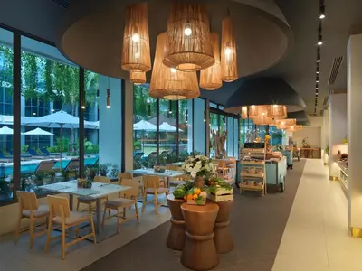 a restaurant with tables and chairs and chandeliers at Layan Green Park by Search Estate 1 bedroom in Ban Nong Chaeng