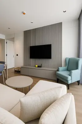 a living room with a tv and a couch and chairs at Layan Green Park by Search Estate 1 bedroom in Ban Nong Chaeng