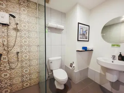 a bathroom with a toilet and a sink and a shower at Recenta Phuket Suanluang by Deevana in Phuket Town