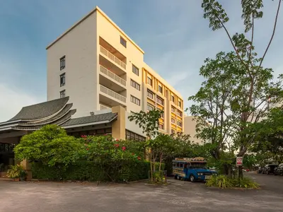 a building with a blue truck parked in front of it at Recenta Phuket Suanluang by Deevana in Phuket Town