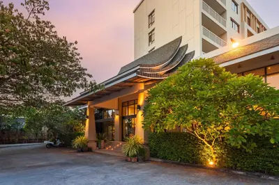 a house with a courtyard in front of it at Recenta Phuket Suanluang by Deevana in Phuket Town