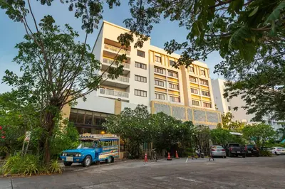 a blue bus parked in front of a building at Recenta Phuket Suanluang by Deevana in Phuket Town