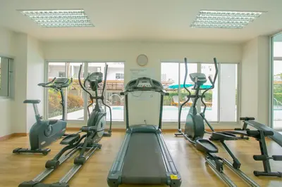 a gym with treadmills and elliptical machines at Recenta Phuket Suanluang by Deevana in Phuket Town
