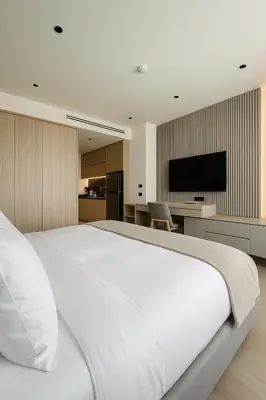 a large white bed in a room with a kitchen at Layan Green Park Studio by Search Estate in Phuket
