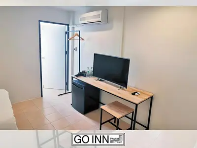 a room with a desk with a computer on it at XX GO INN Seng Ho Phuket - โอลทาวน์ Oldtown in Phuket Town