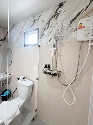 a bathroom with a toilet and a shower at The Sense in Patong Beach
