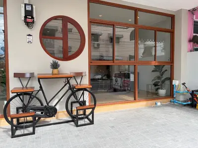 a bike parked next to a building with a mirror at The Sense in Patong Beach