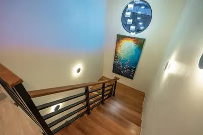 a staircase in a house with a painting on the wall at Lakeside 5-BR New Pool Villa in Gated Community in Chalong