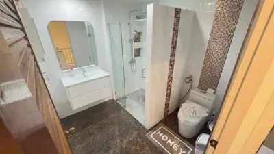 a bathroom with a shower and a toilet and a sink at Family House Patong - Homestay in Patong Beach