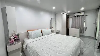a bedroom with a large white bed in it at Family House Patong - Homestay in Patong Beach