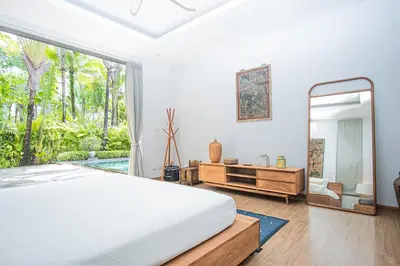 a bedroom with a large bed and a mirror at Luxury Pool Villa a Short Walk from Bangtao Beach in Bang Tao Beach