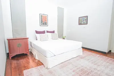 a bedroom with a large white bed and a night stand at Luxury Pool Villa a Short Walk from Bangtao Beach in Bang Tao Beach