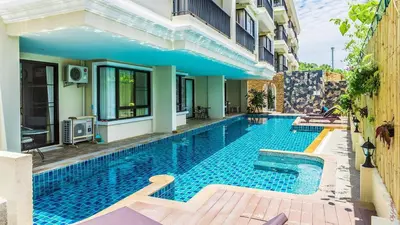 a swimming pool in front of a building at The Lago Nai Harn 2 Bedrooms by ALL HOMES in Rawai Beach