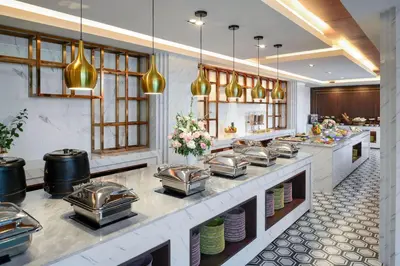 a large kitchen with a counter with food at Private Villa at Mida Grande Resort in Surin Beach