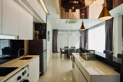 a kitchen with white cabinets and a dining room at Private Villa at Mida Grande Resort in Surin Beach