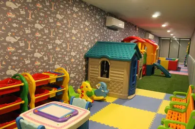a childs play room with a toy house and play equipment at Private Villa at Mida Grande Resort in Surin Beach