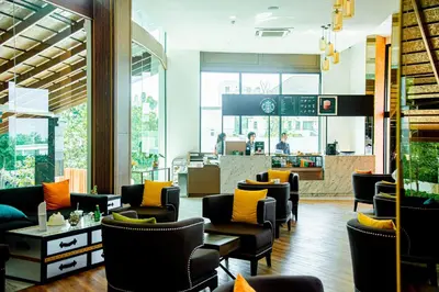 a lobby with couches and chairs and a restaurant at Private Villa at Mida Grande Resort in Surin Beach