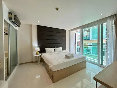 a bedroom with a large bed and a large window at The Bay Cliff Kalim 1 Large Bedroom by ALL HOMES in Patong Beach
