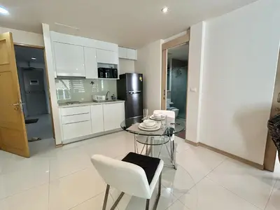 a kitchen with a glass table and a refrigerator at The Bay Cliff Kalim 1 Large Bedroom by ALL HOMES in Patong Beach