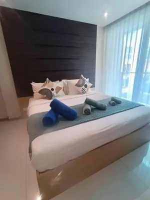 a bedroom with two beds with blue pillows at The Bay Cliff Kalim 1 Large Bedroom by ALL HOMES in Patong Beach