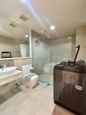 a bathroom with a toilet and a glass shower at The Bay Cliff Kalim 1 Large Bedroom by ALL HOMES in Patong Beach